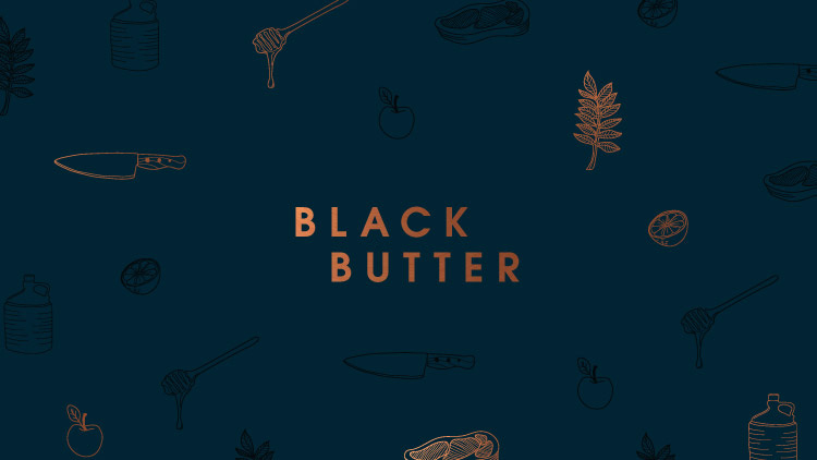 The Black Butter logo. Displayed in the brand colour pf copper and set in capital letters. The background is a dark teal. There are brand illustrations surrounding the logo which include a liquorice leaf, a lemon cut in half, a honey drizzler with honey dripping off, a chef's knife, a steak, an apple and a cider demijohn.