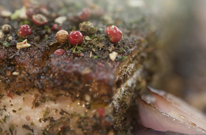 Close up photograph of a pork belly with Bloody Mary Rub.